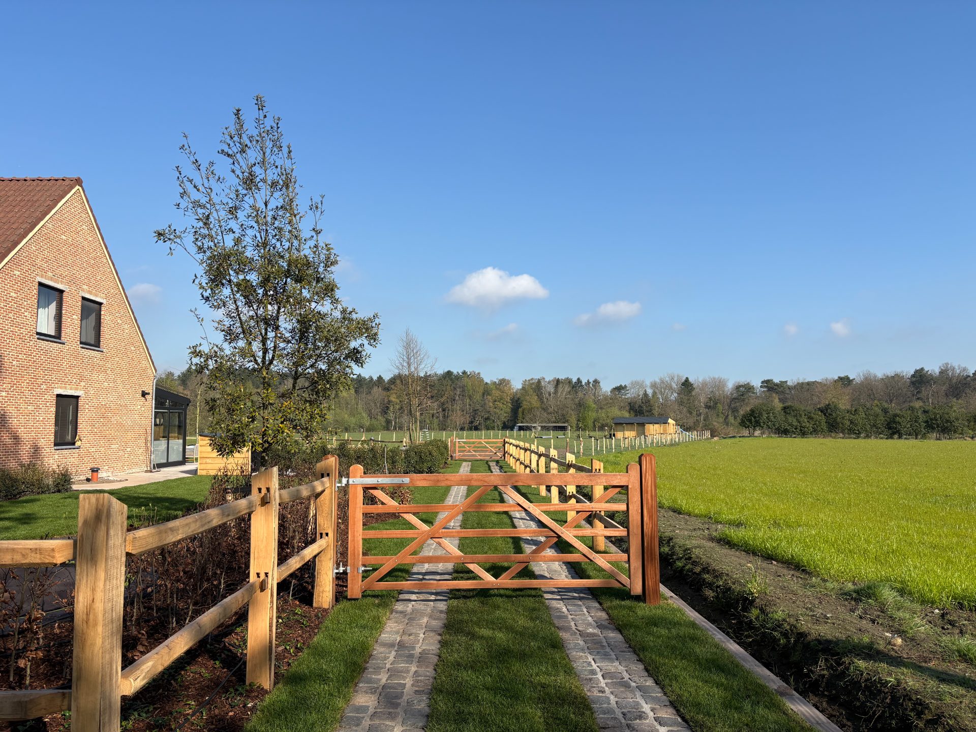 Hardwood driveway gates on cobbles
