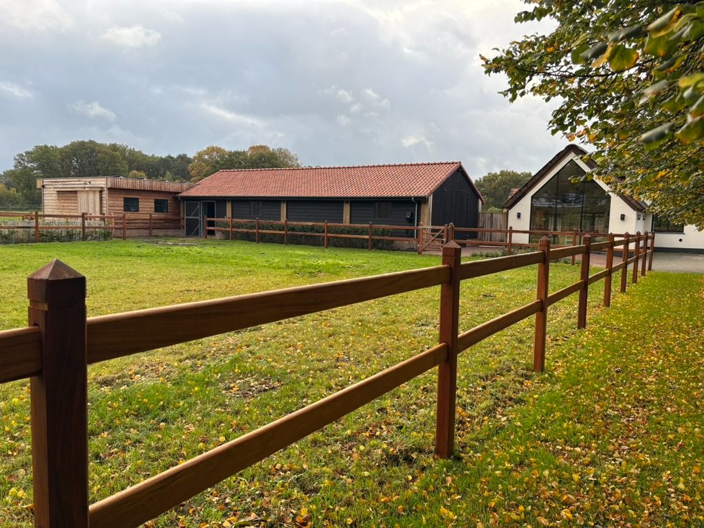 Okan two-rail pasture fencing at a farmhouse