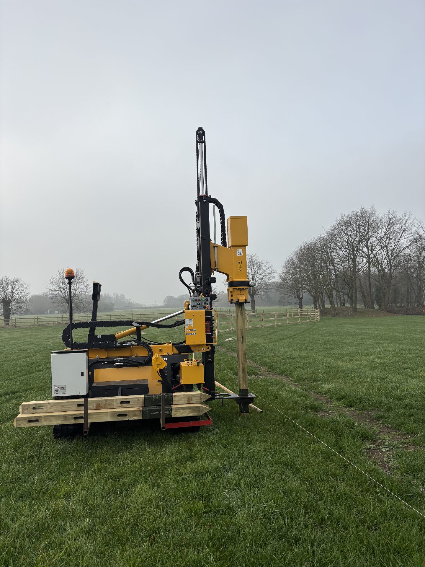 Post-driving machine at work