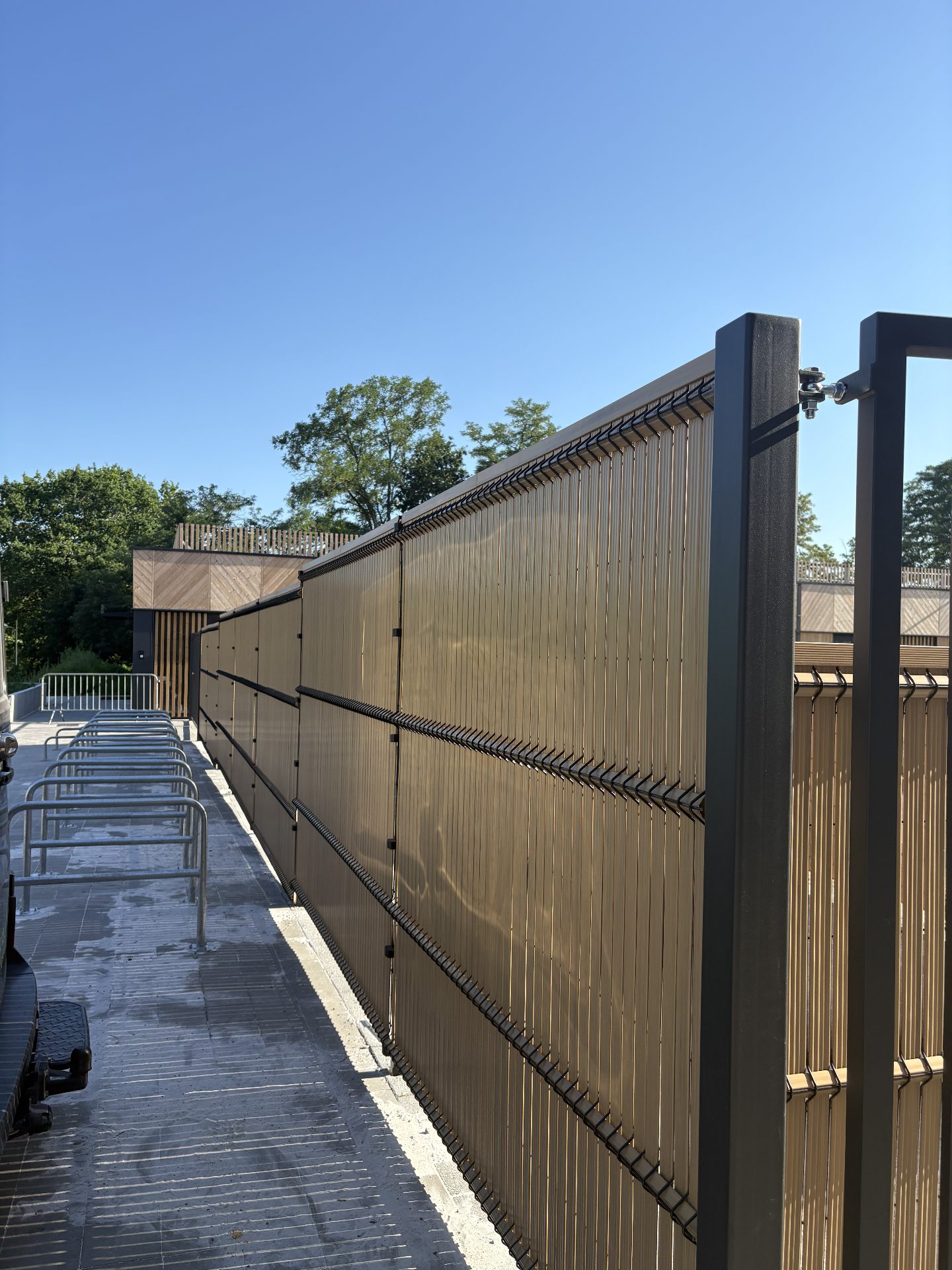 Steel posts with wooden slat infill at a commercial site
